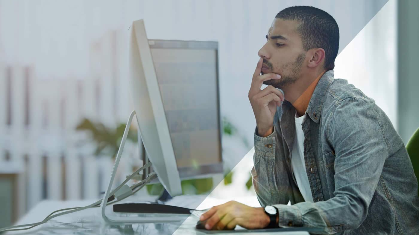 Man working on two screens