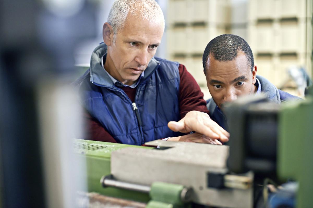 Two workers operating machinery