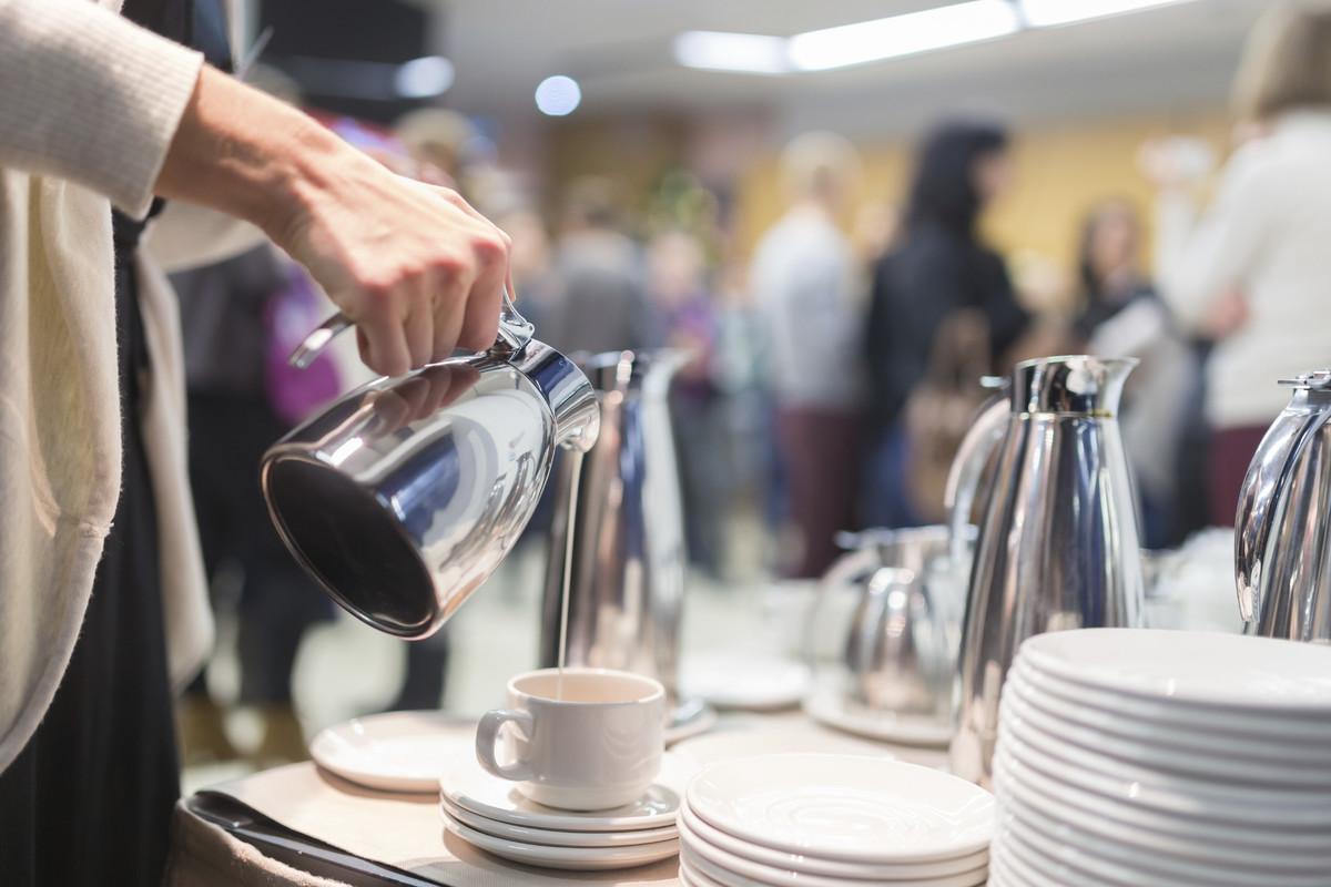 Pouring hot drink at event