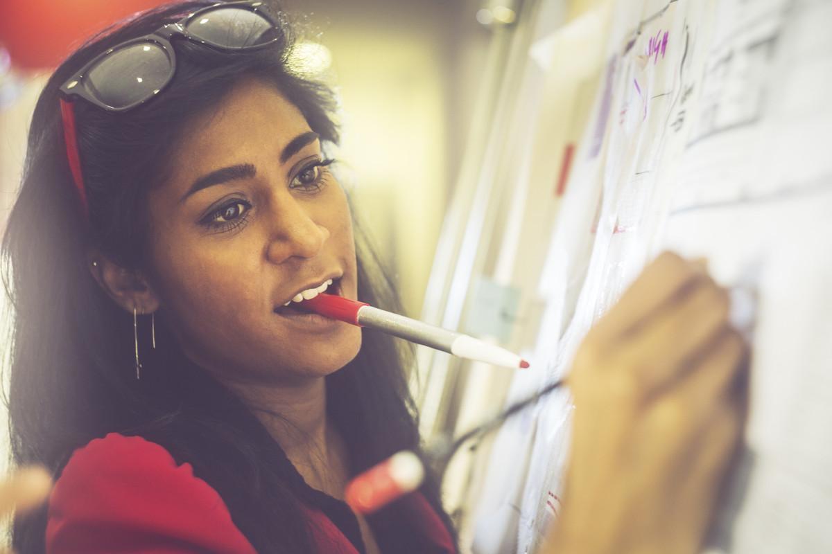 Woman writing on whiteboard