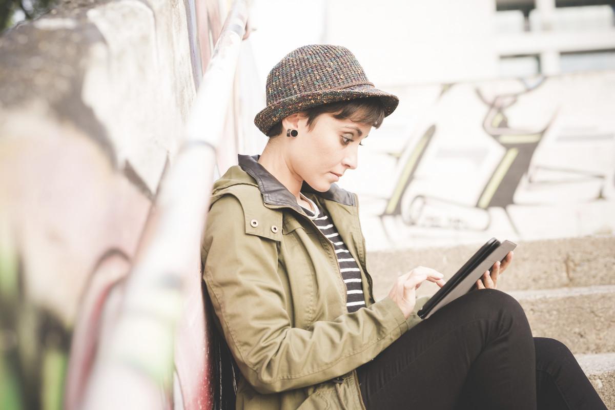 Girl sat down on tablet