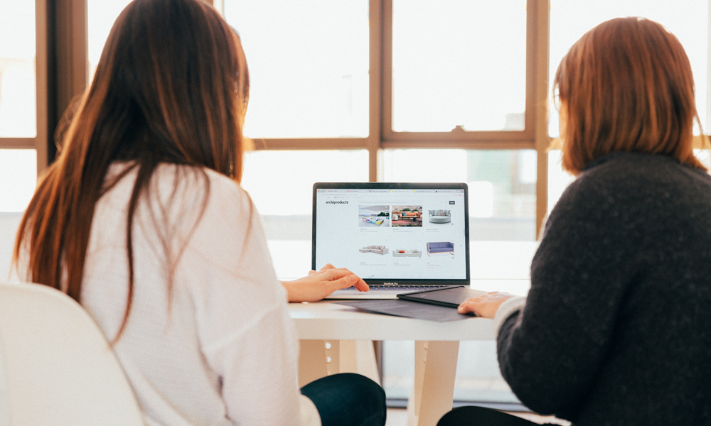 Two women looking at laptop