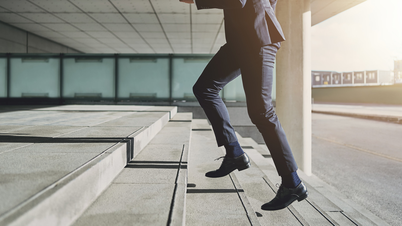 Man wearing suit runs up the stairs
