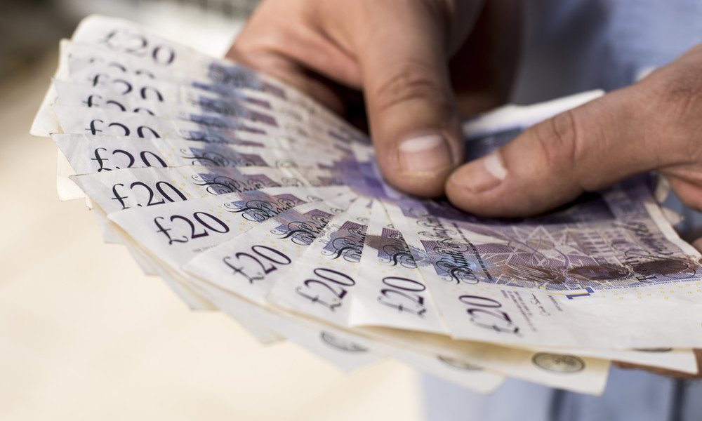 Twenty pound banknotes in man's hands