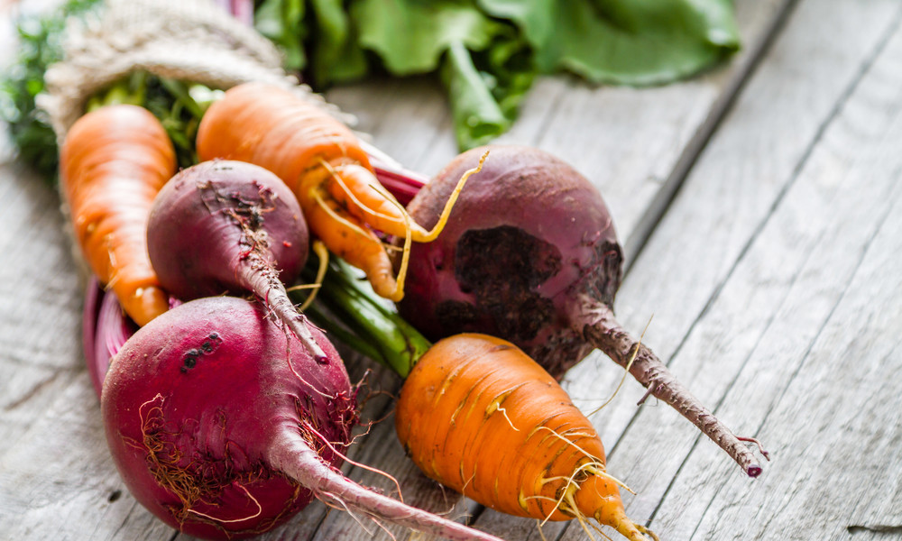 Carrot and beet on rustic background